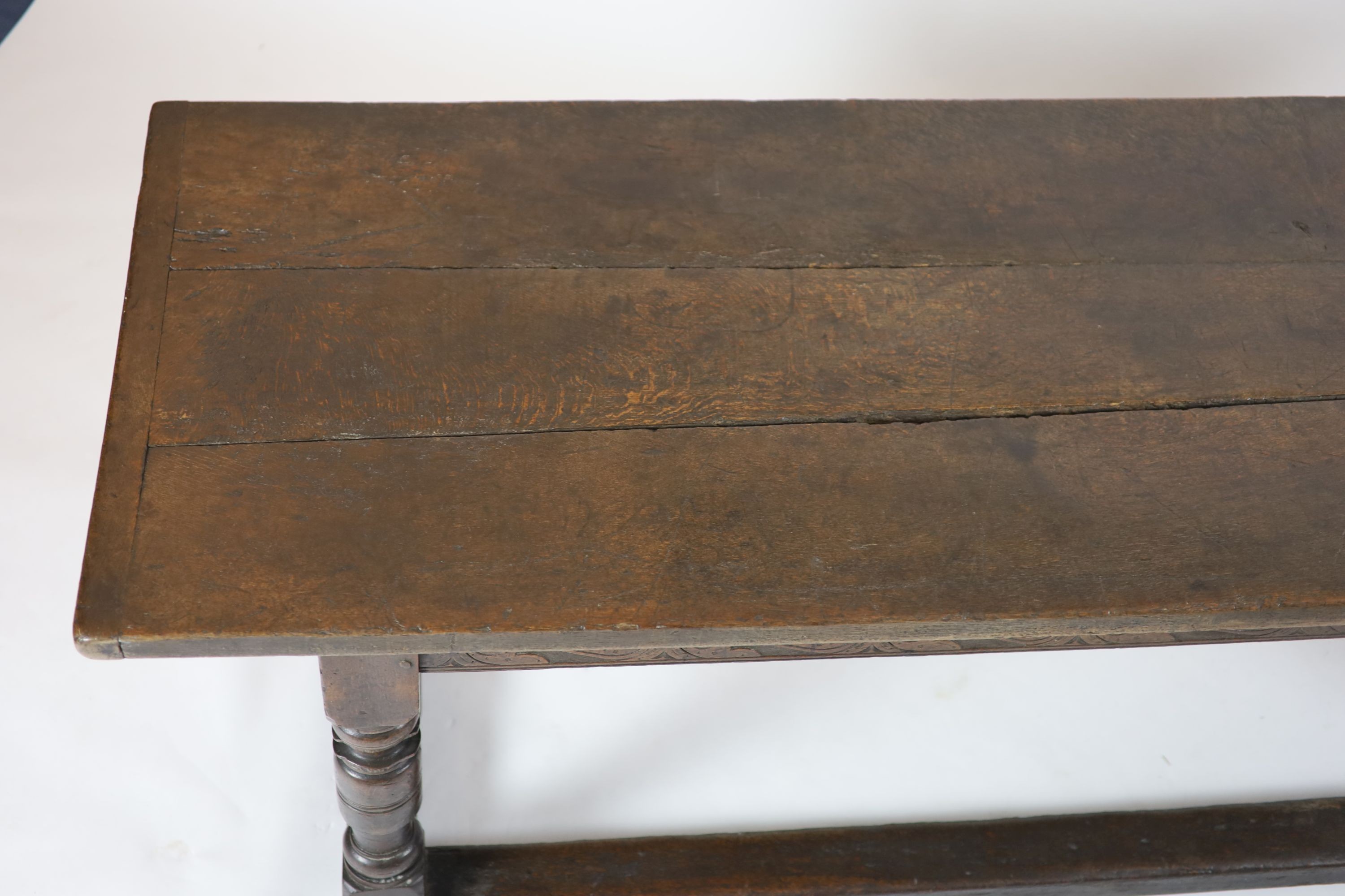 A Charles I oak refectory table, possibly West Country, having three-plank top H 74cm. W 220cm. D 76cm.